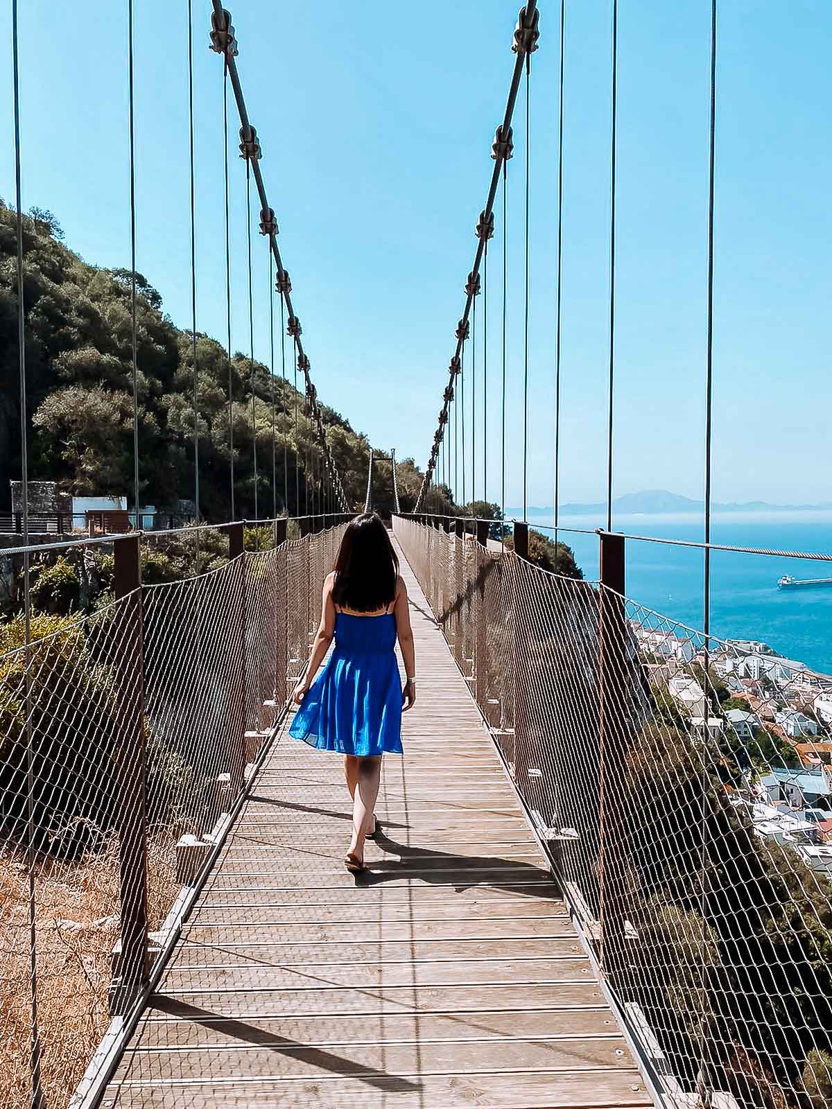10 Best Things to Do in Gibraltar (Itinerary Included) 7 Cristina walking on the suspension bridge at the top of the rock in gibraltar.