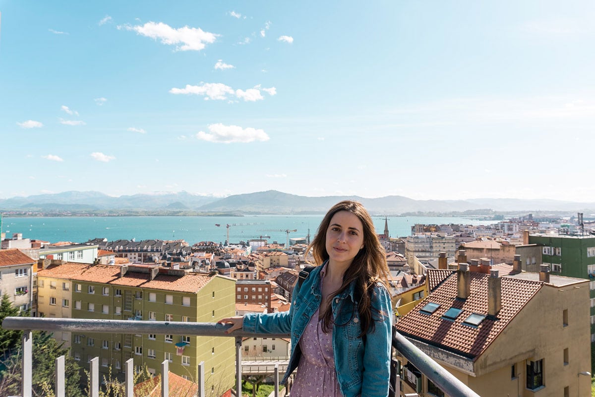 Cristina posing with a background of Santander city centre, sea and mountains.