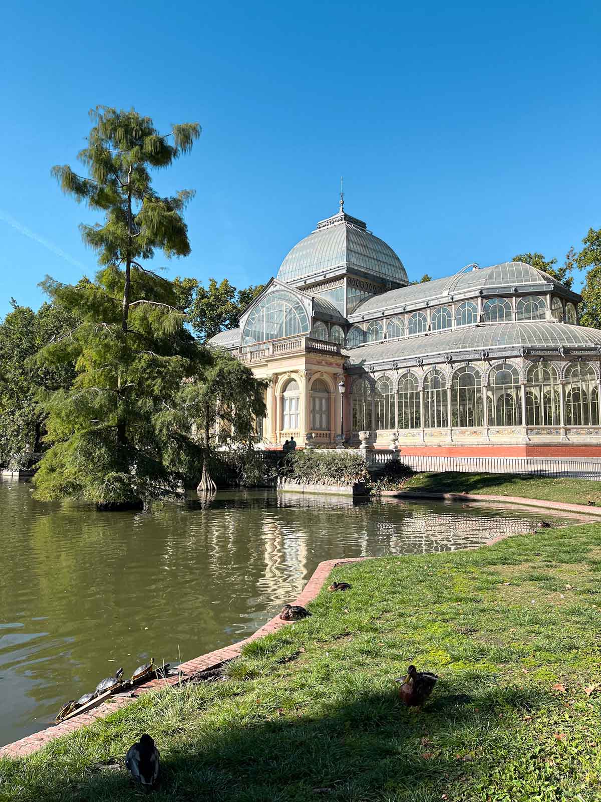 Palacio de Cristal and lake in El Retiro Park in Madrid, Spain.