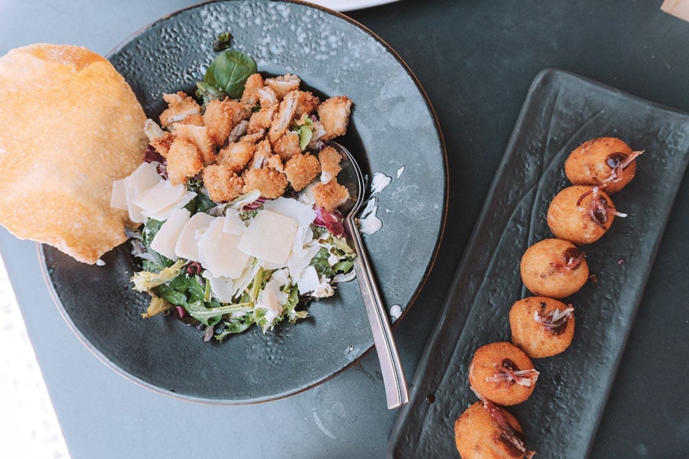 caesar salad and serrano ham croquettes