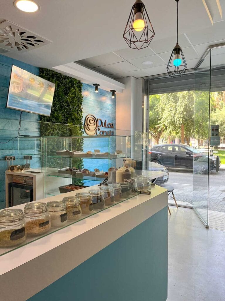 A photo of the glass counter of Dulce Canela cafe in Malaga, Spain.