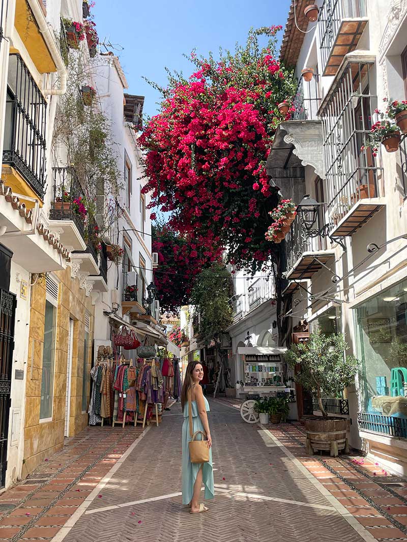 a woman walking on a street in Marbella Old Town, Spain