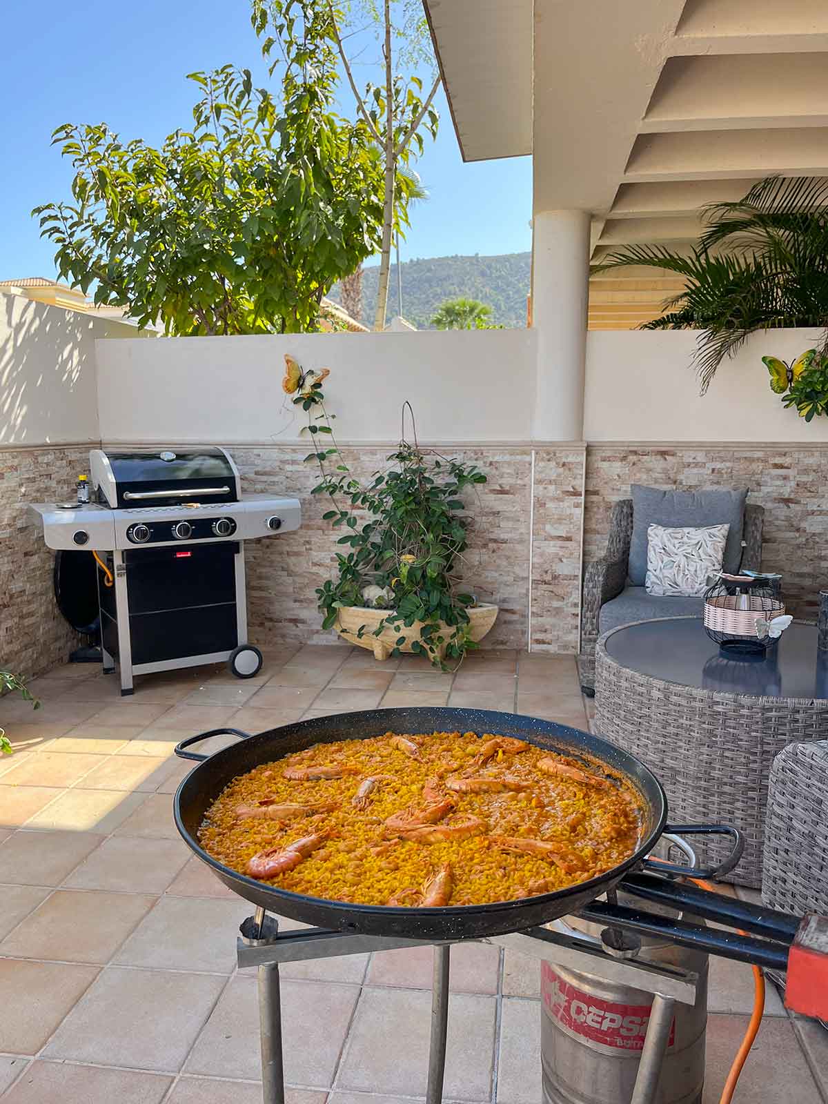Making seafood paella in a small patio.