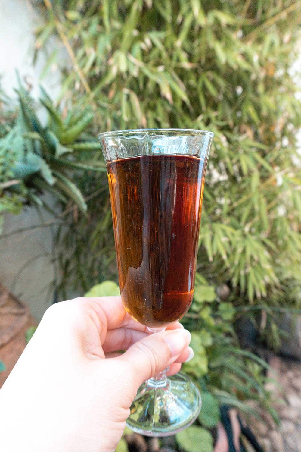 5 Best Wine Tours in Malaga and its Surroundings 5 a close up photo of a glass with sweet wine of comares, malaga.