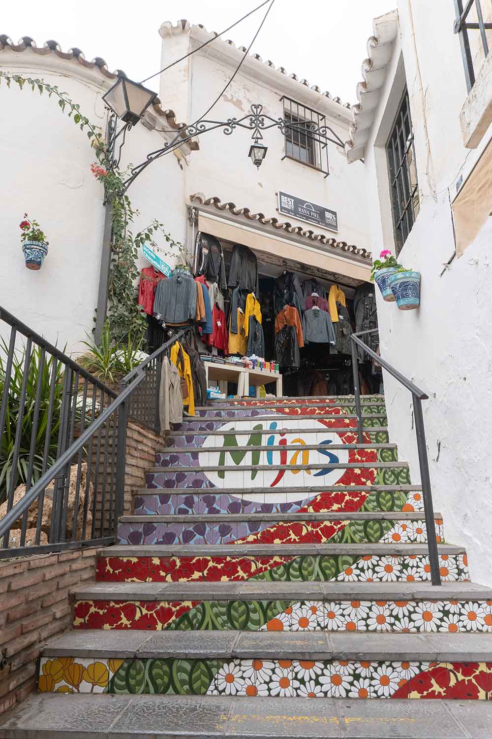 Stairs with colourful tiles that read mijas.