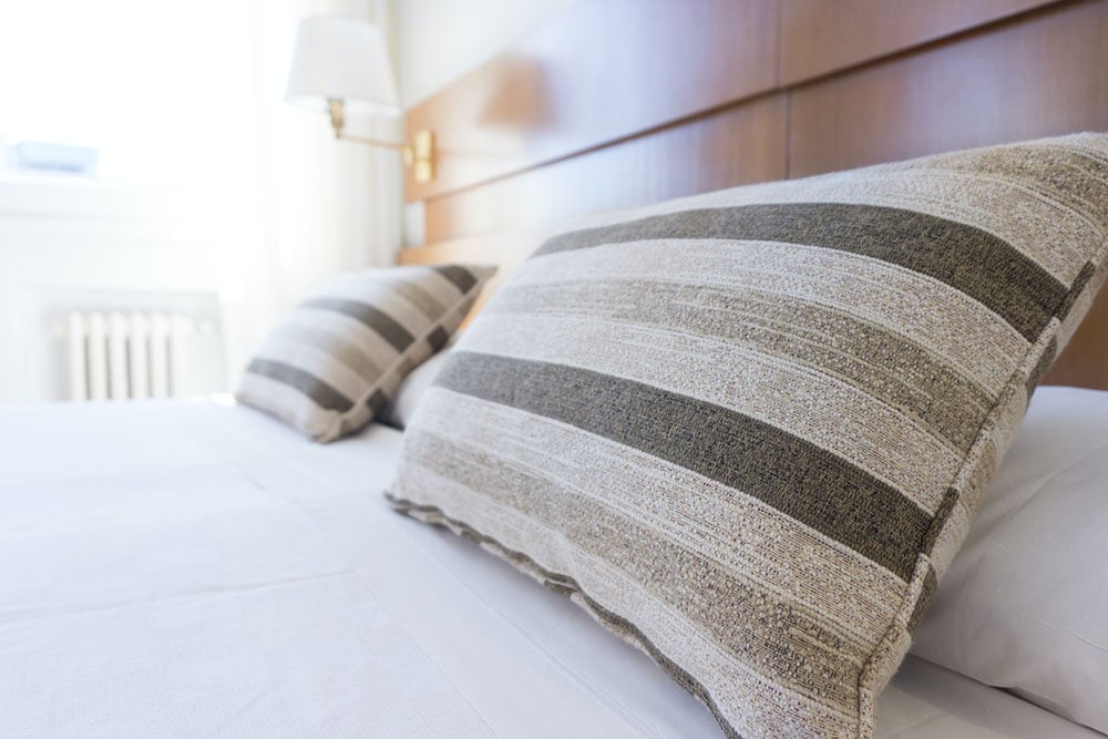 Close up photo of two pillows in a bed of a hotel.