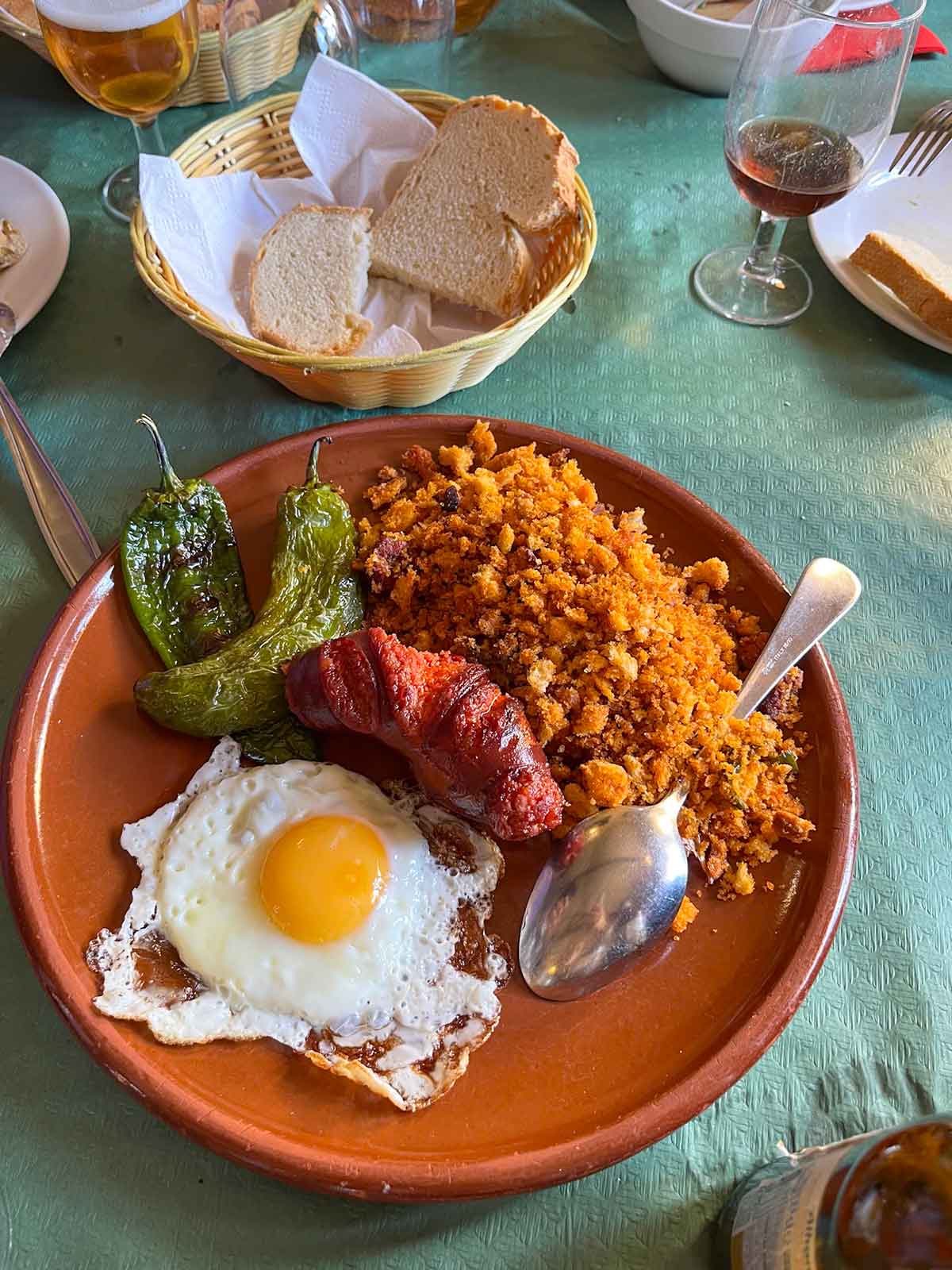 What to Eat in Malaga (Food Guide by a Local) 11 Traditional Spanish migas served with a fried egg and chorizo.