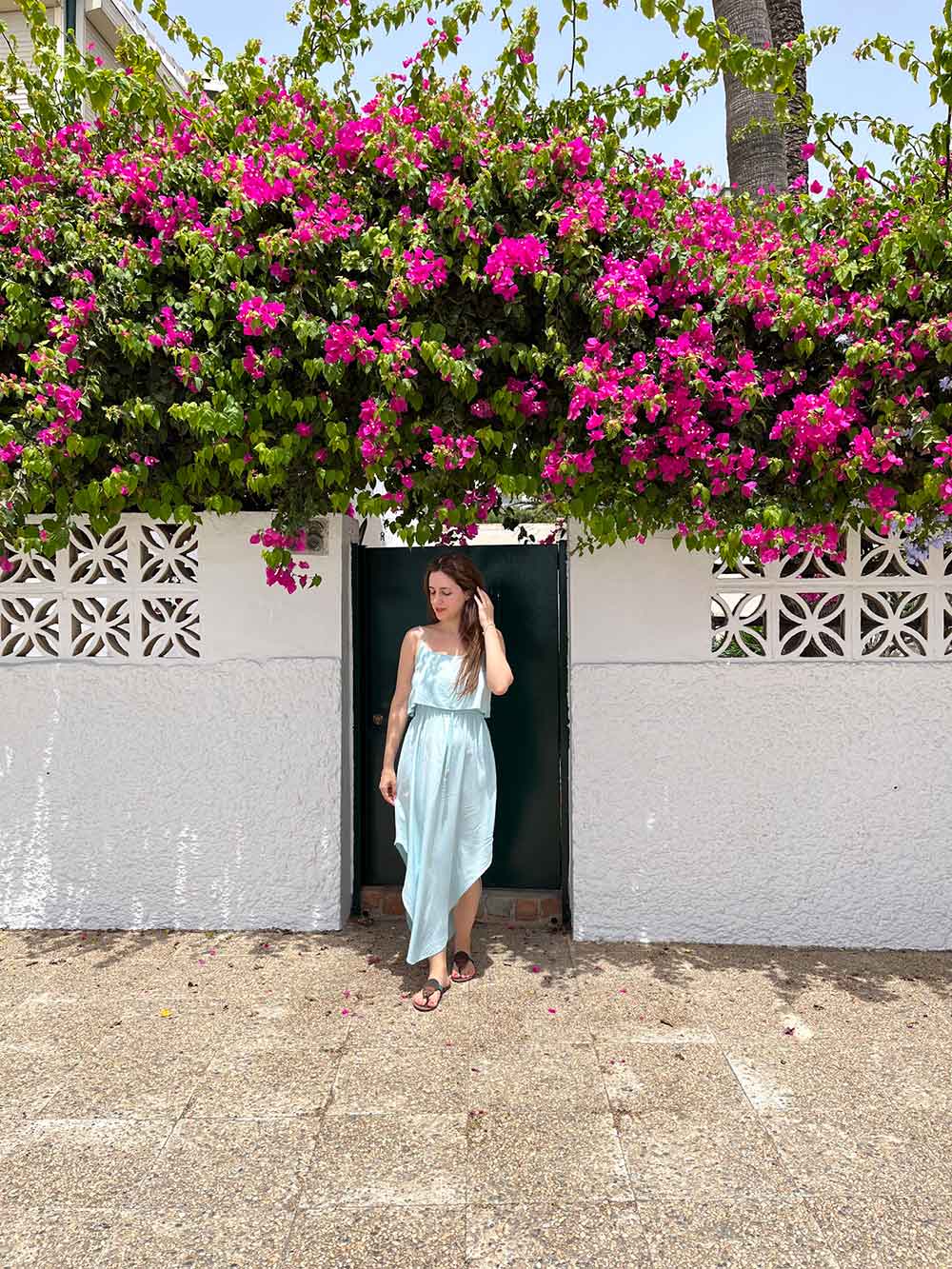Pedregalejo: Malaga's Traditional Fishing Neighbourhood 16 Cristina in front of a house with bougainvillea flowers in Pedregalejo, Malaga, Spain
