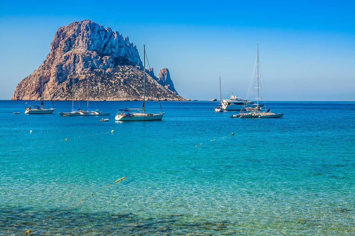 Rock formation and boats in Ibiza, Spain.