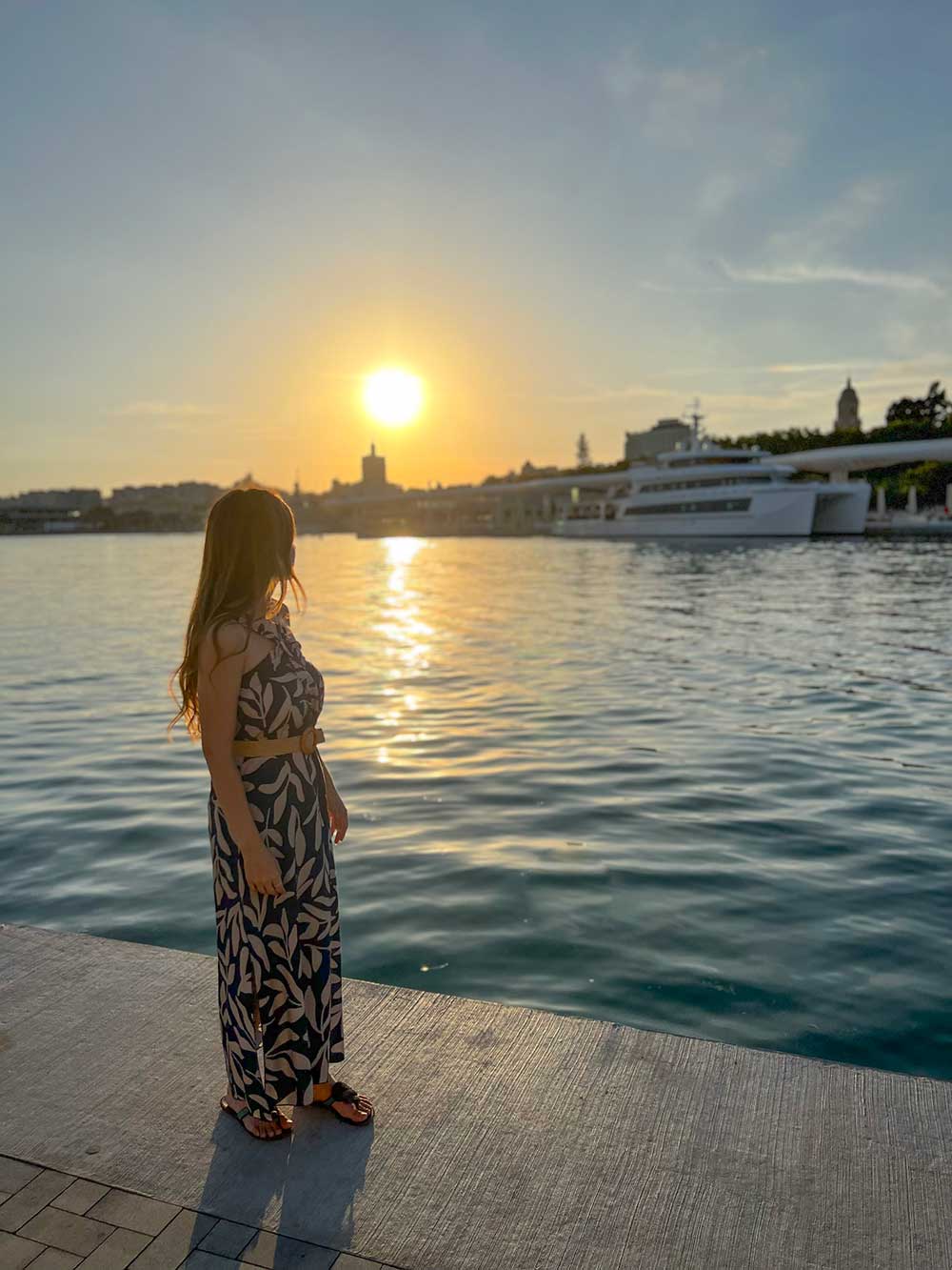 11 Best Views in Malaga that Will Amaze You 13 Cristina contemplating the sunset at Muelle Uno, Malaga's Port.