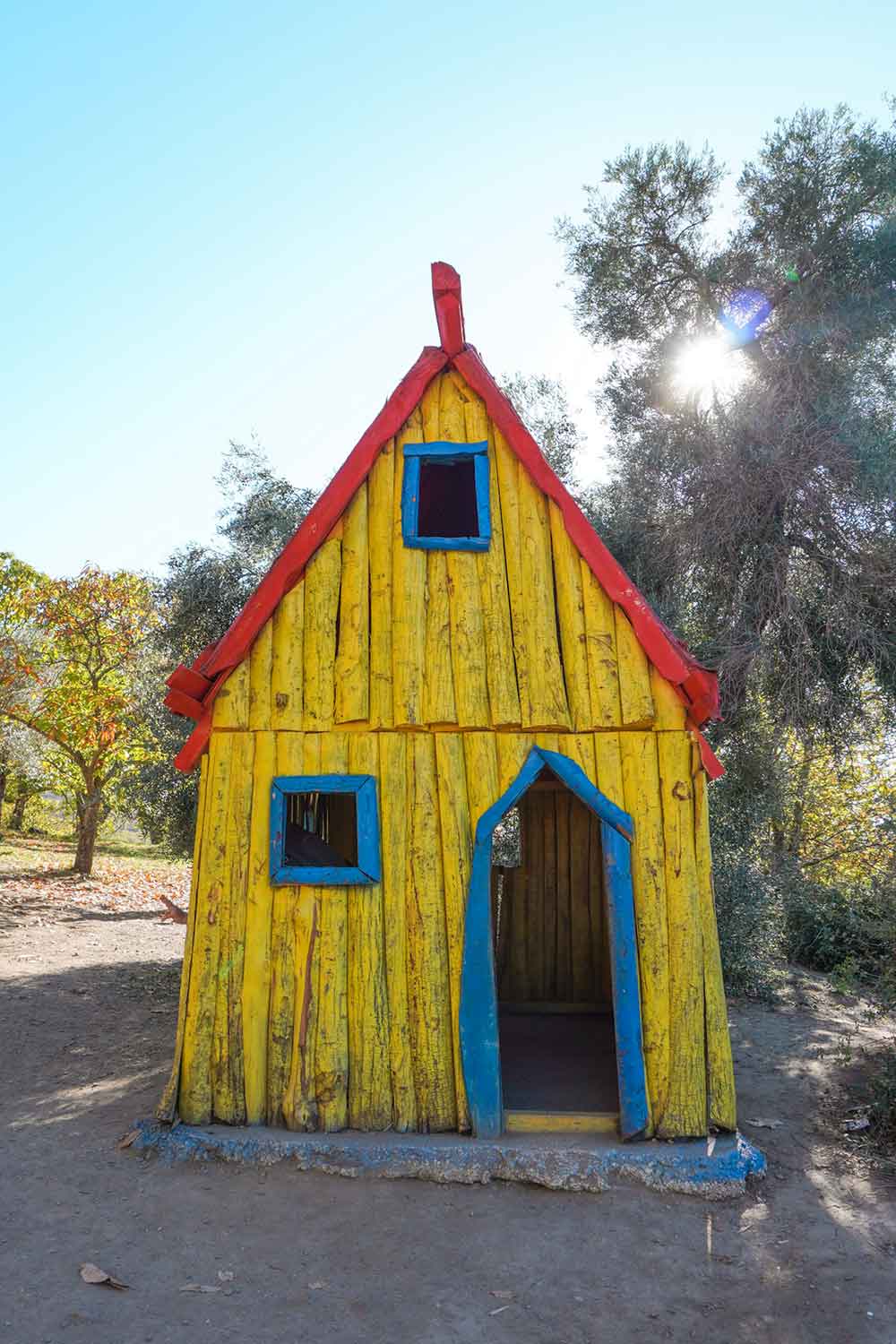 Yellow painted wooden house in the enchanted forest in Parauta, Malaga, Spain.