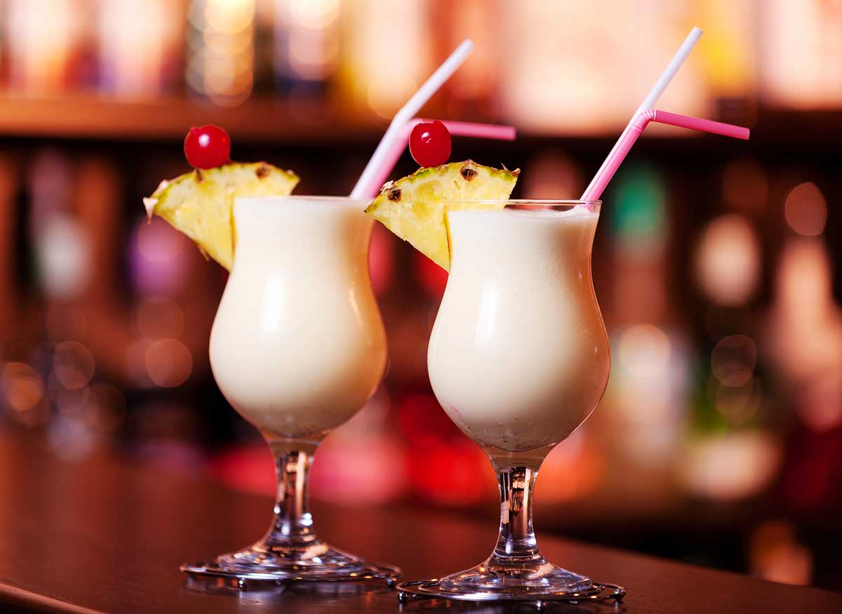 A close up photo of two pina coladas.