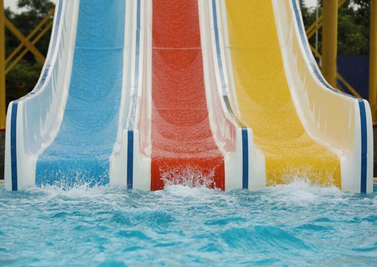 A close up photo of colourful slides at the waterpark.