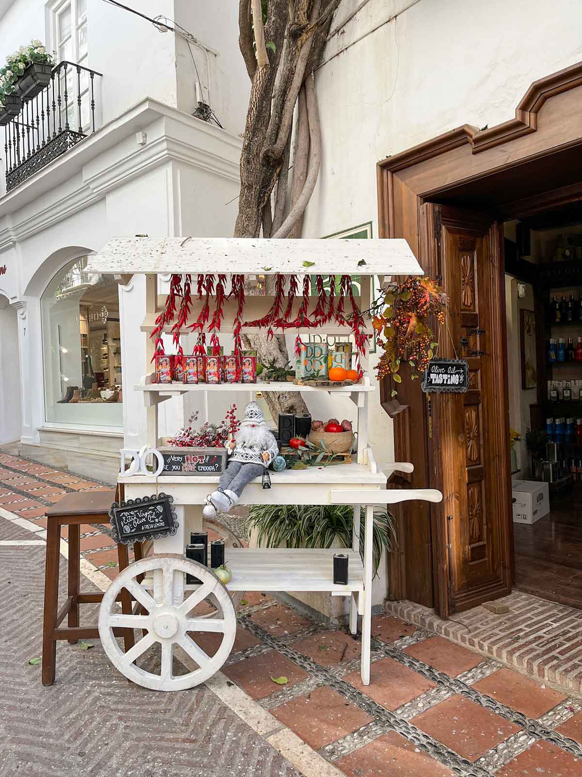How to Spend 4 Days in Marbella (Slow Travel Guide) 18 Olive oil tasting stall outside D Oliva shop in Marbella historic centre.