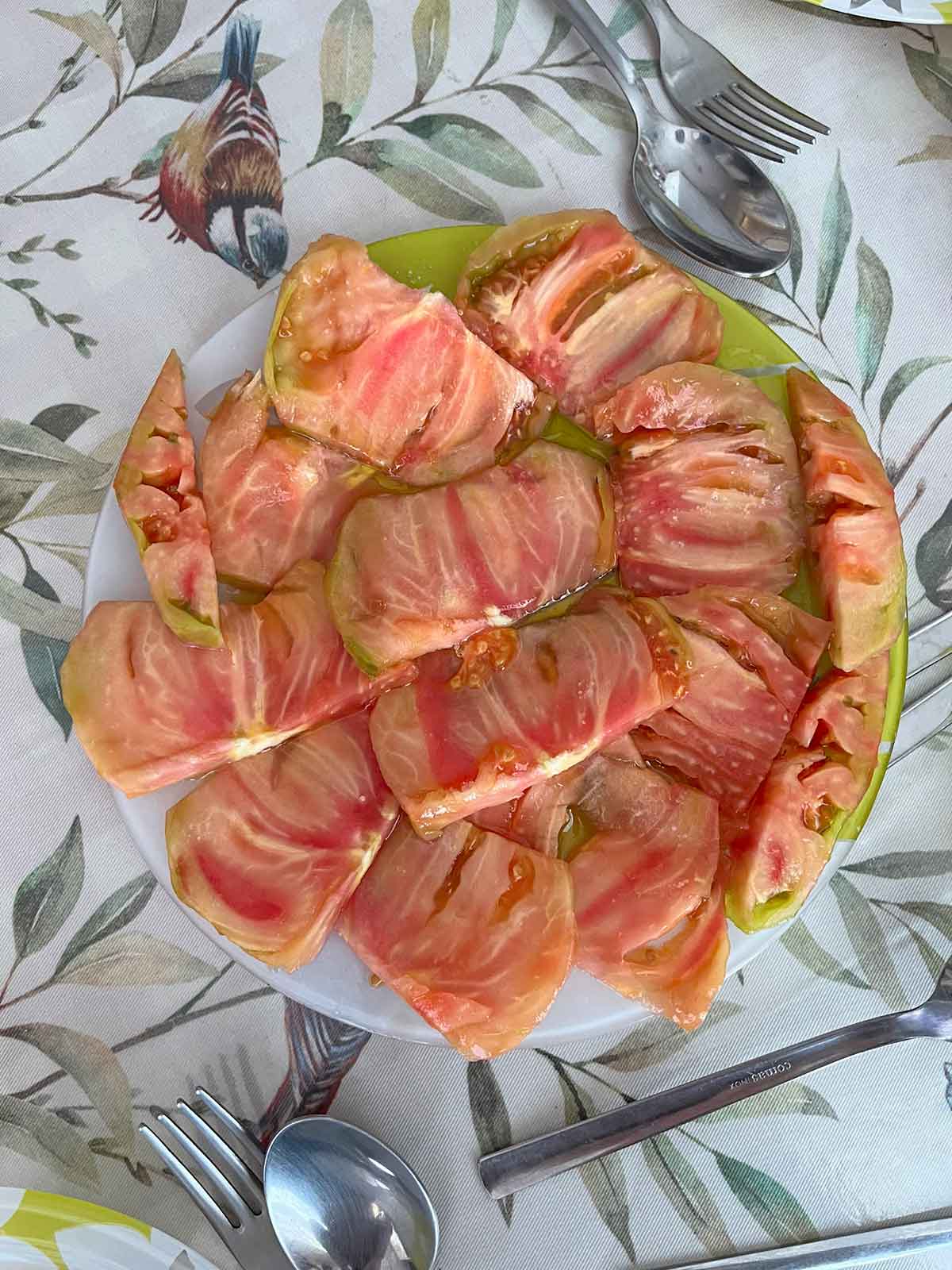 Sliced tomato with olive oil and salt.