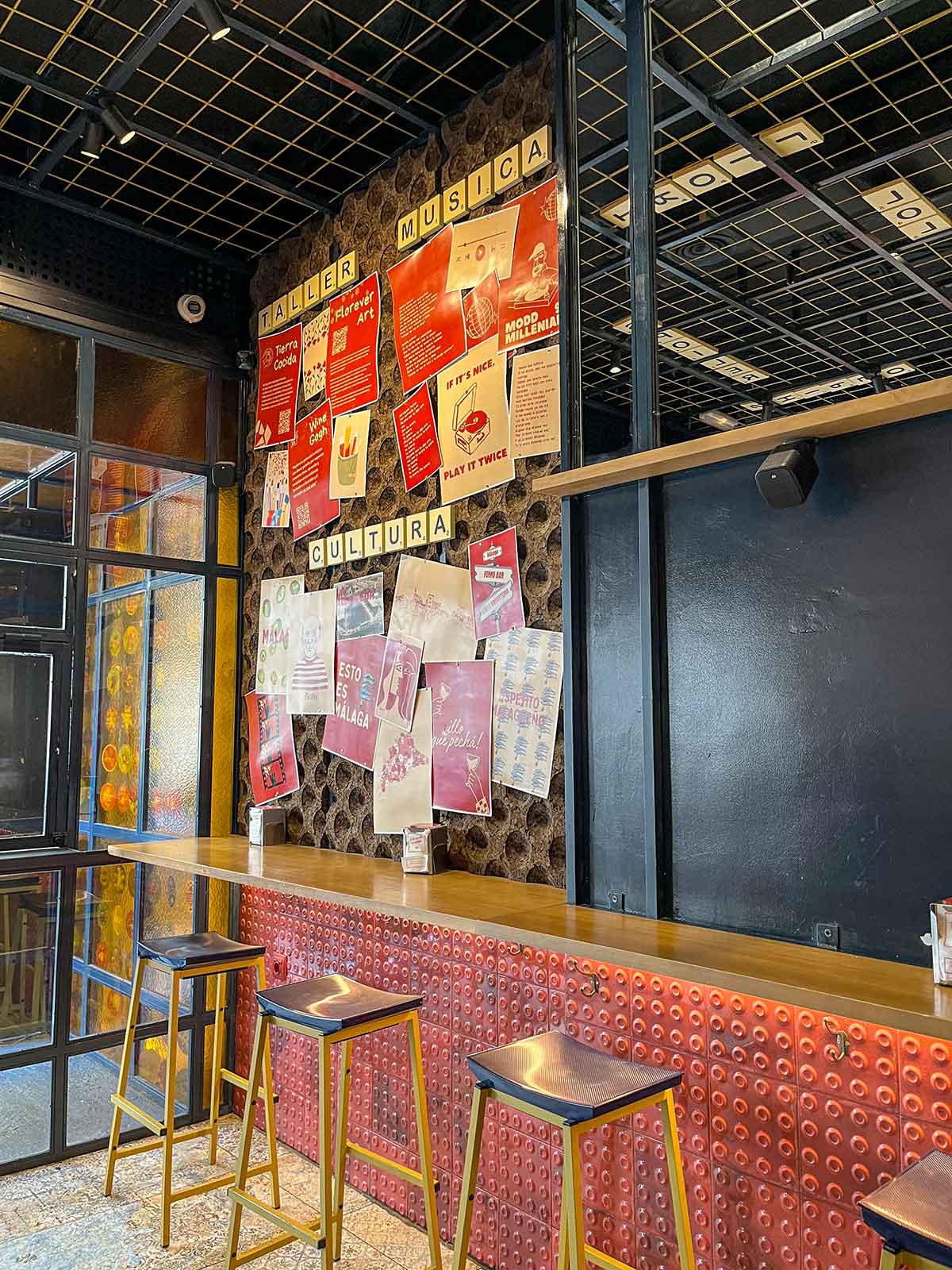 Tables and decoration at Fomo Bar in Malaga, Spain.