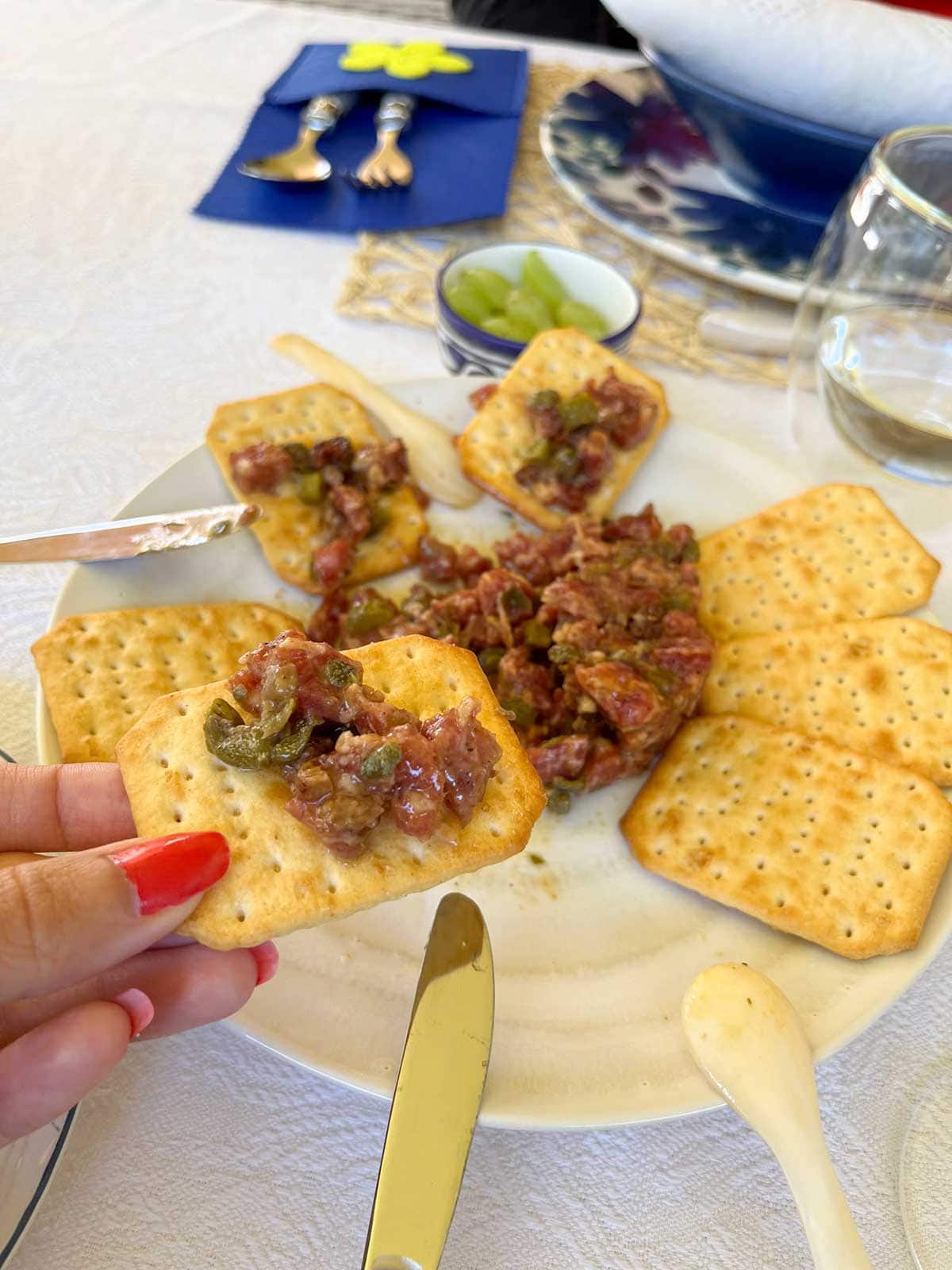 A close up photo of a tartar made with salchichon, a sausage typical of Malaga.