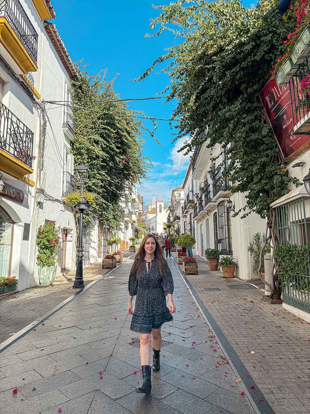 Cristina walking down Calle Ancha street in Marbella Old Town.
