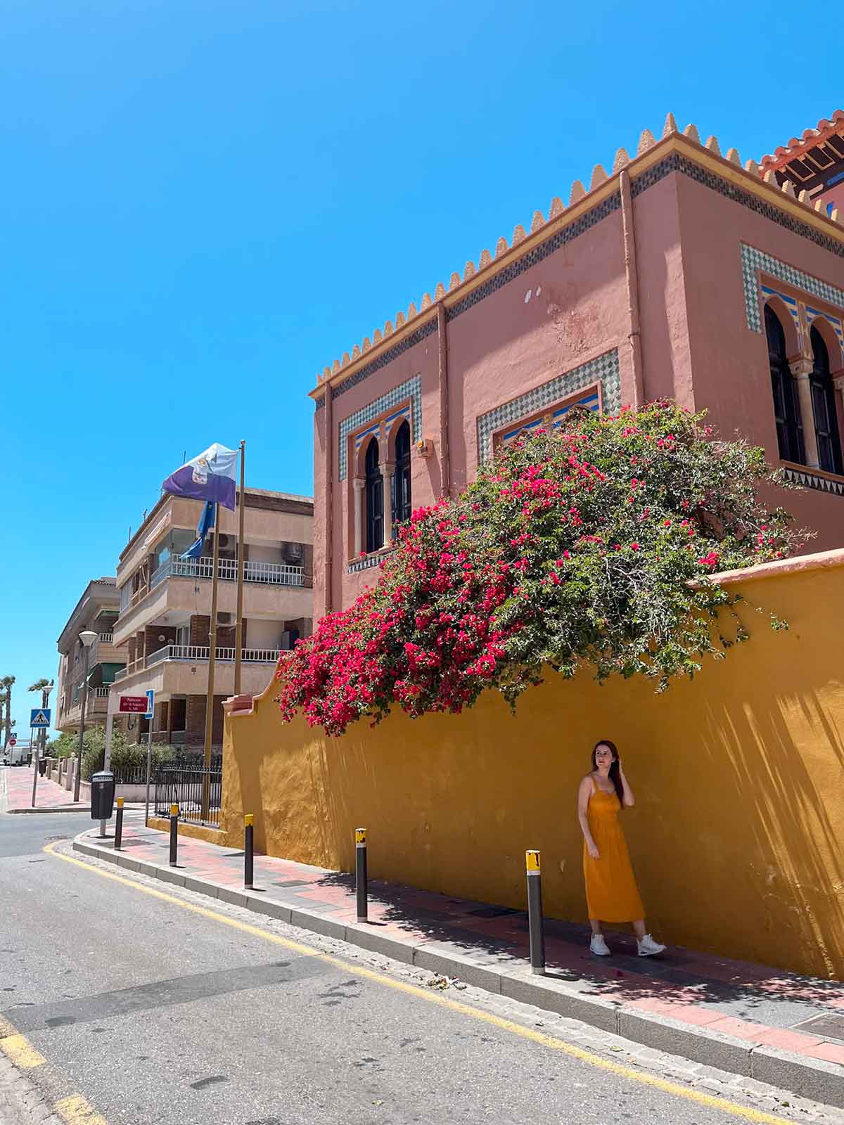 Cristina walking down the street next to the Almuñecar tourist office.