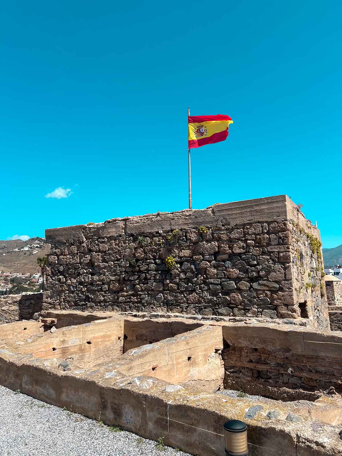 Spain flag in a tower at the San Miguel Castle in Almunecar, Granada.