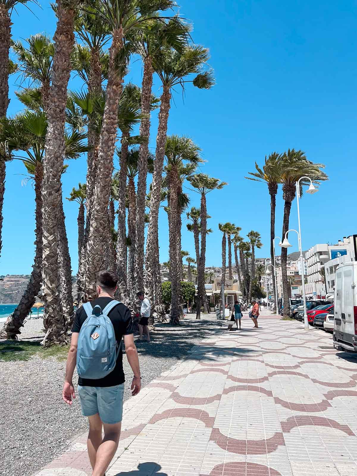 Man walking on San Cristobal Beach promenade in Almunecar.