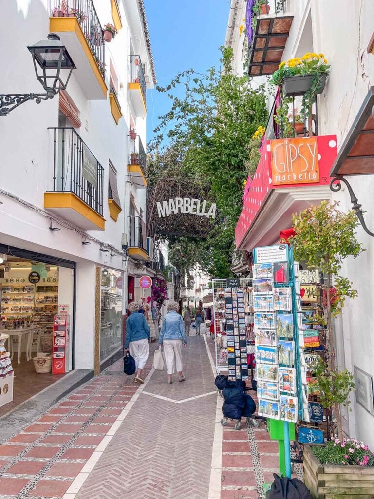 How to Spend 4 Days in Marbella (Slow Travel Guide) 4 A photo of two women walking down Calle Nueva in Marbella Old Town.