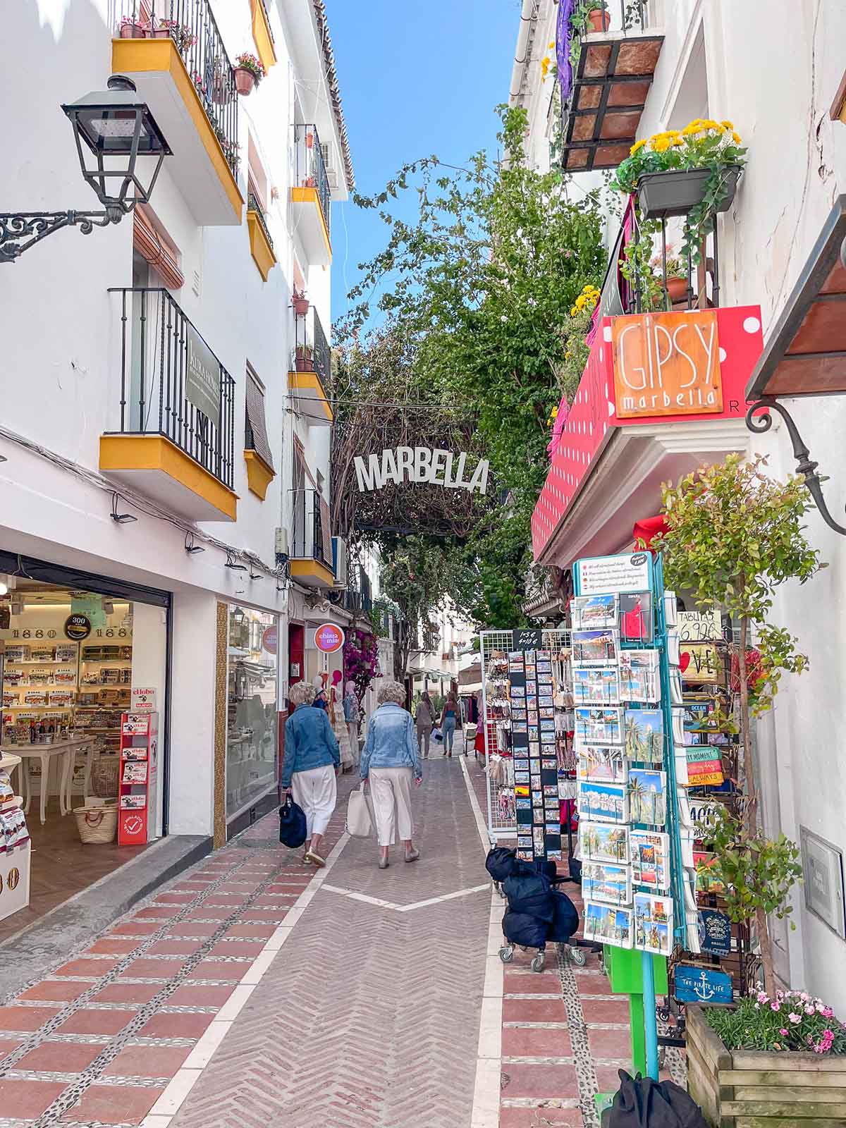 13 Fun Things to Do in Marbella in October + Local Insights 2 A photo of two women walking down Calle Nueva in Marbella Old Town.