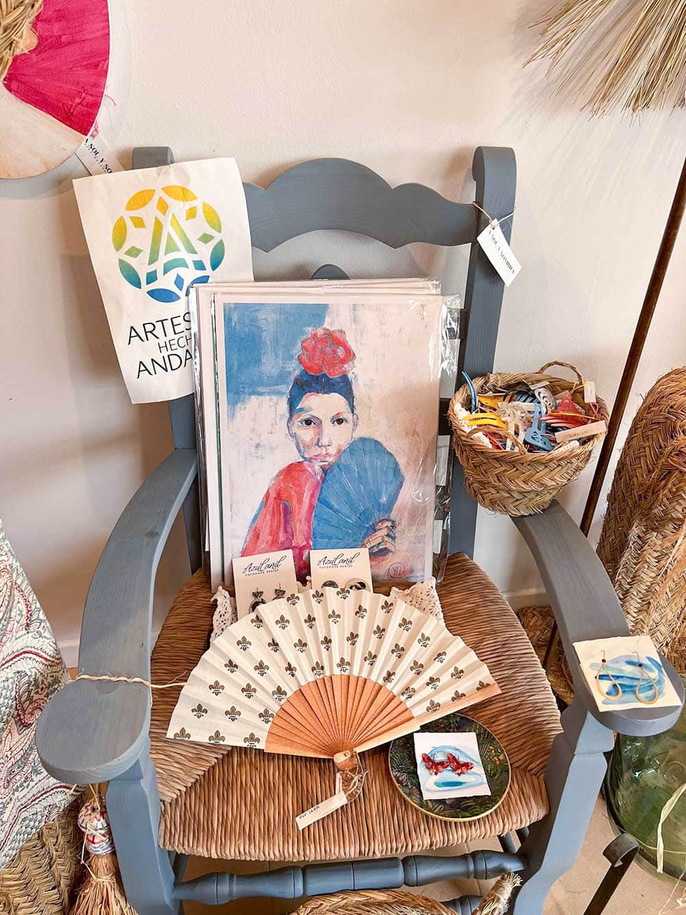 A painting of a woman wearing a flamenco dress, a Spanish fan and other small items.
