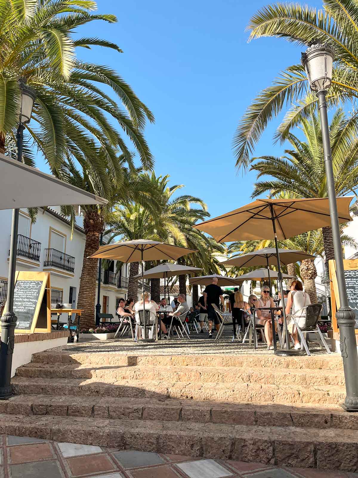 18+ Fun Things To Do In Benalmadena By a Local 9 A square with palm trees in Benalmadena Pueblo.