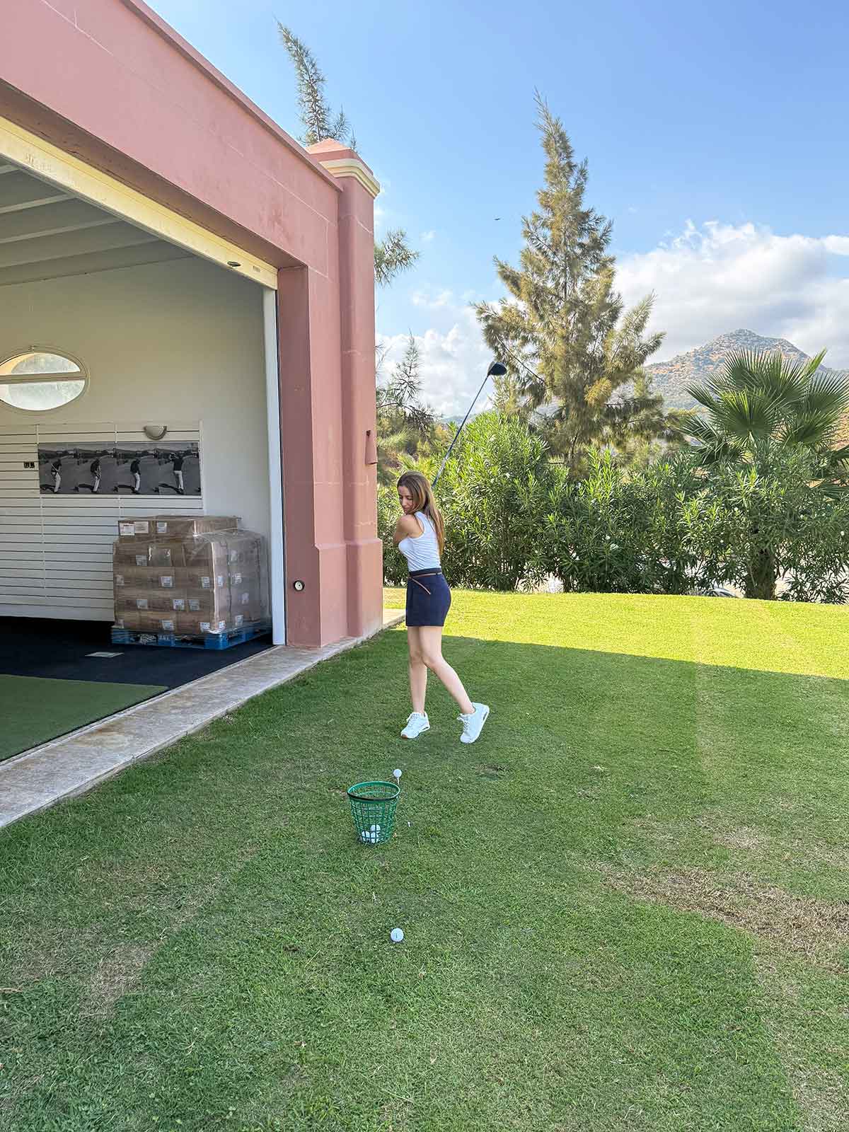 Marbella in November: 14 Things to Do, Weather + Local Tips 25 Cristina learning how to play golf at Villa Padierna Golf Marbella.