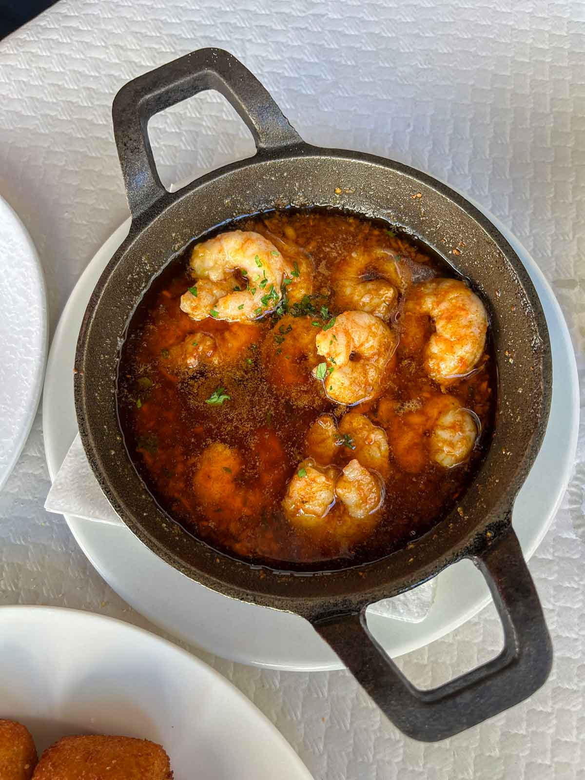 What to Eat in Malaga (Food Guide by a Local) 8 A close up photo of pil pil prawns.