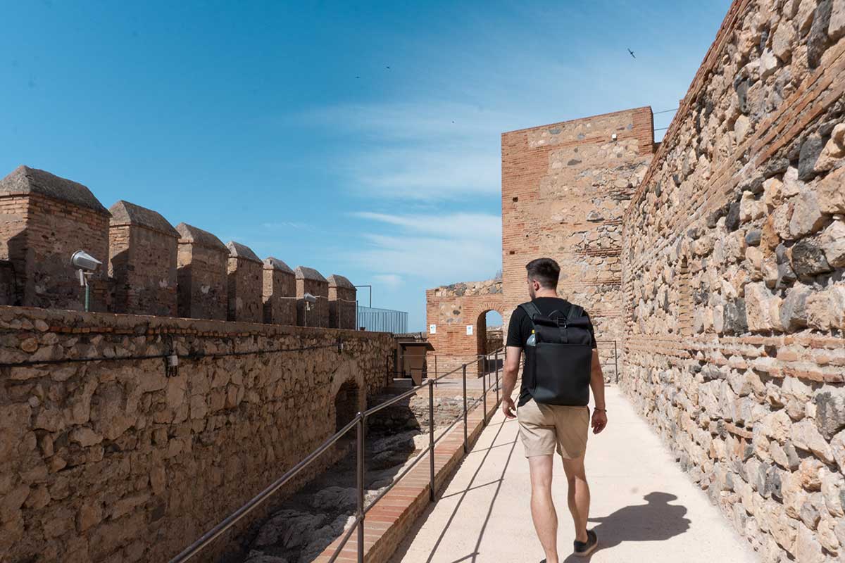 Man walking inside Salobreña Castle in Granada, Spain.