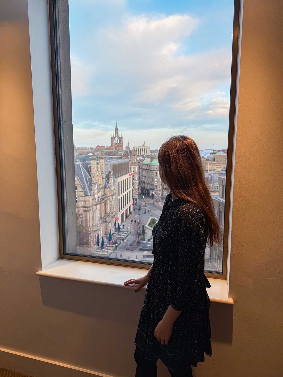 LEVEL8 Grace Carry-on Luggage Review 3 Cristina admiring Newcastle city views from her hotel.