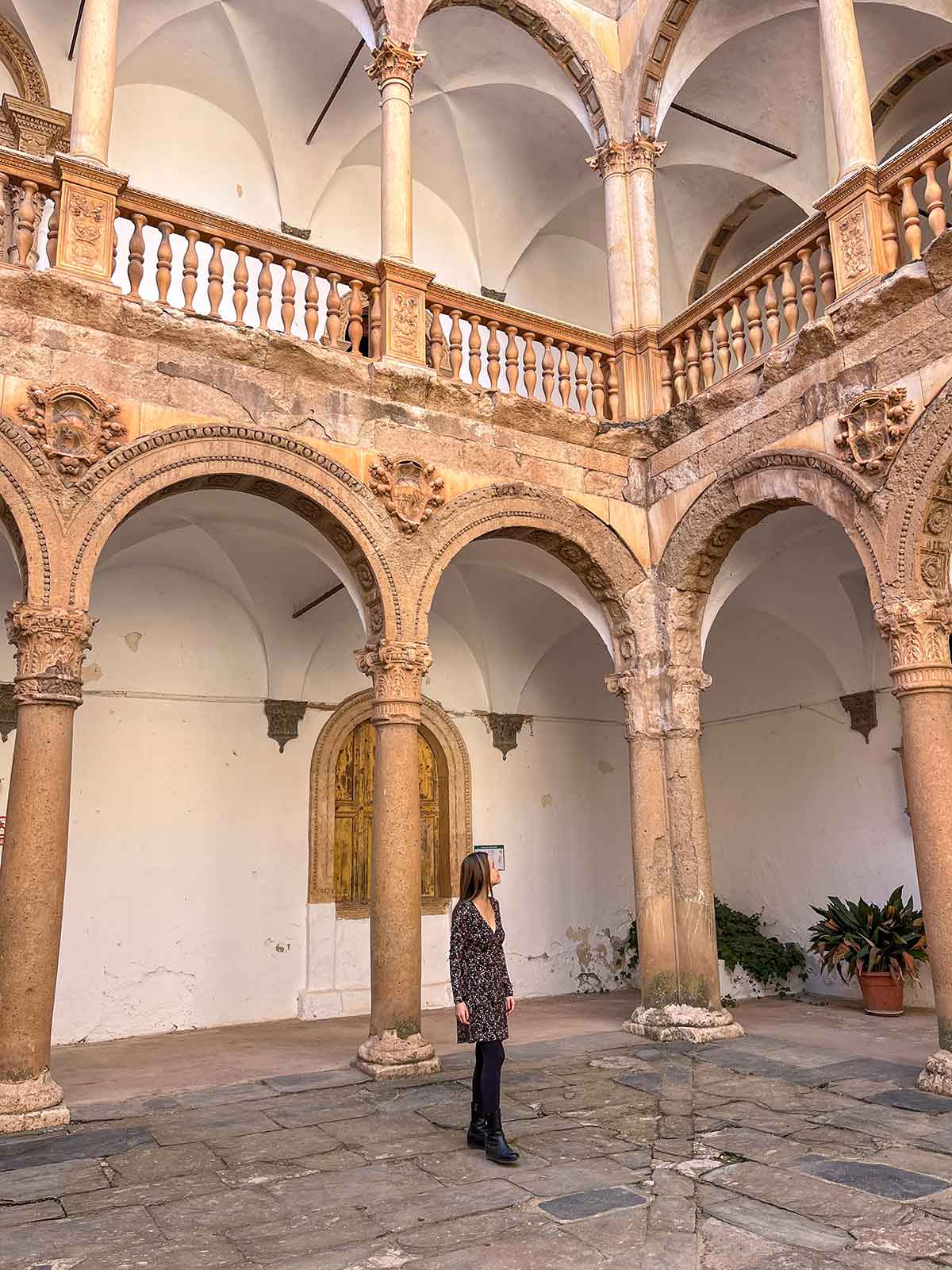 Woman wandering the main courtyard in La Calahorra Castle.