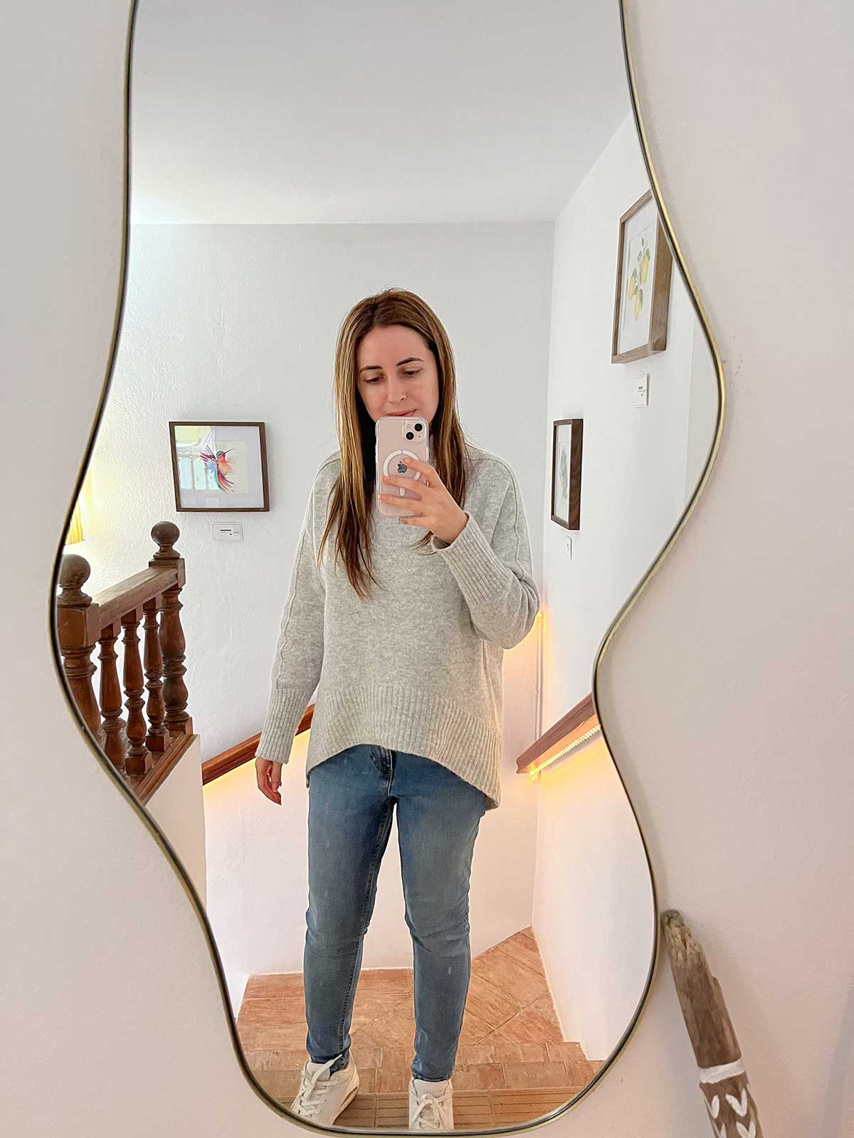 Woman taking a photo in the mirror inside Brisa Specialty Coffee in Rincon de la Victoria.