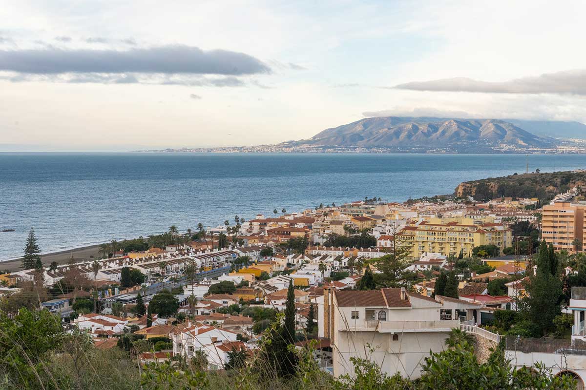 A panoramic view of El Rincon de la Victoria with the sea and mountains in the background during early hours of the morning.