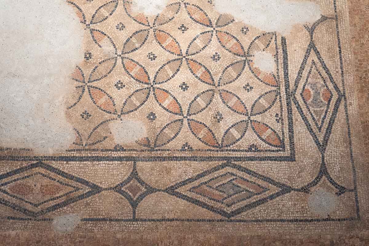 A close up photo of the mosaic floor with circle patterns at Villa Antiopa.