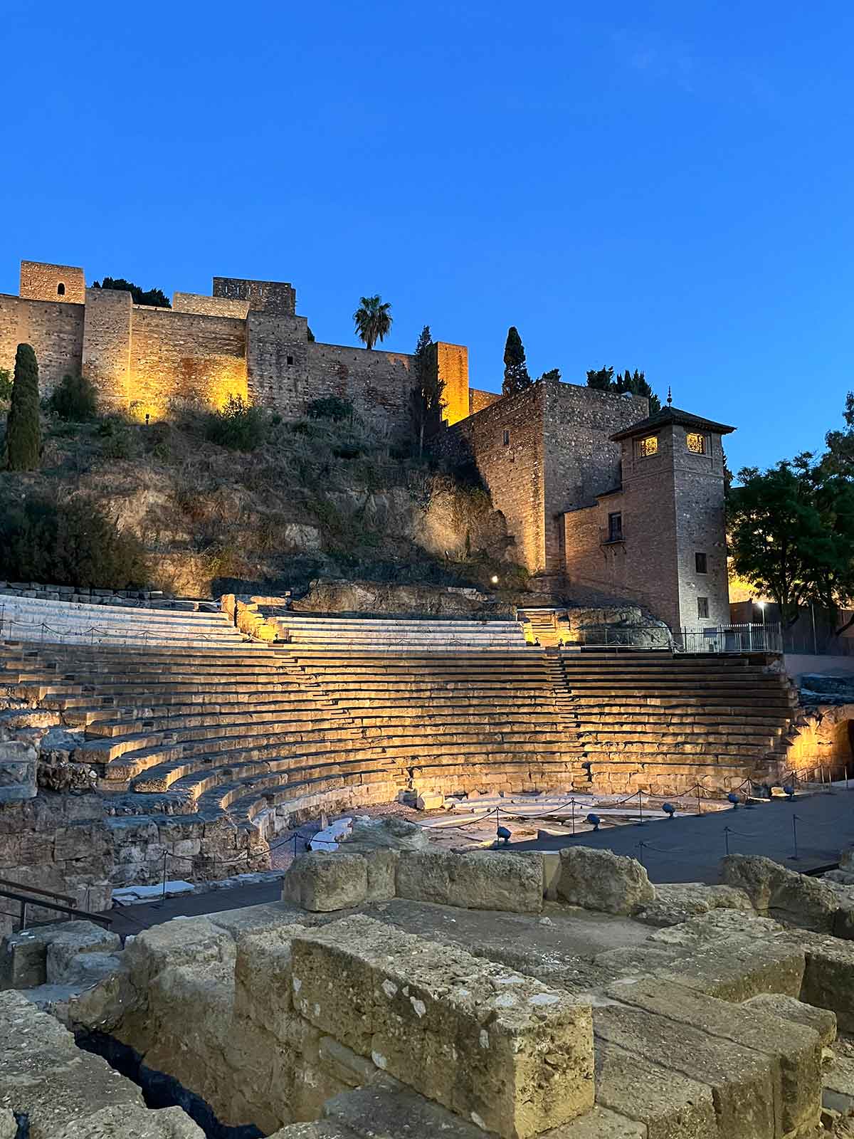 Roman Theatre and Alcazaba de Malaga illuminated at night.