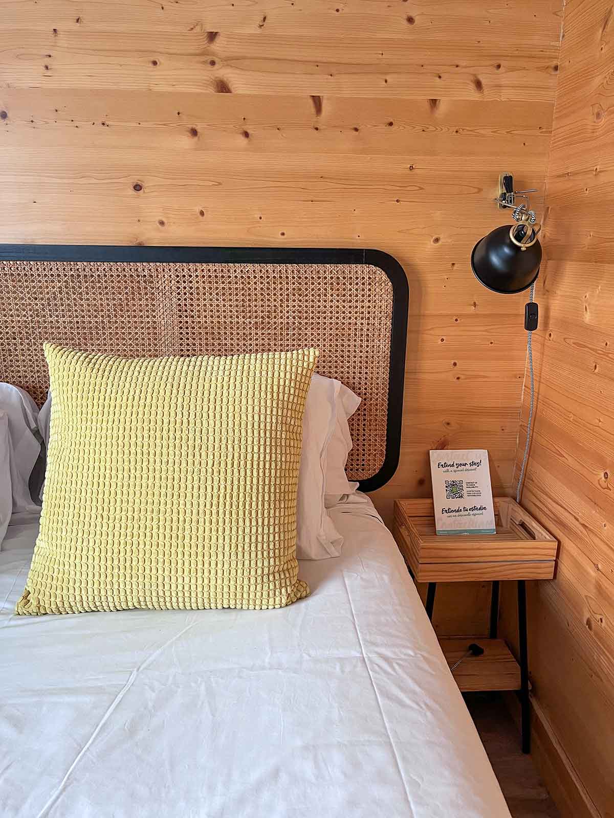 My Review Of Boat Haus, The Floating Hotel in Cadiz 5 A close up photo of the bed with a yellow pillow at the Boat Haus modern boathouse in La Linea.