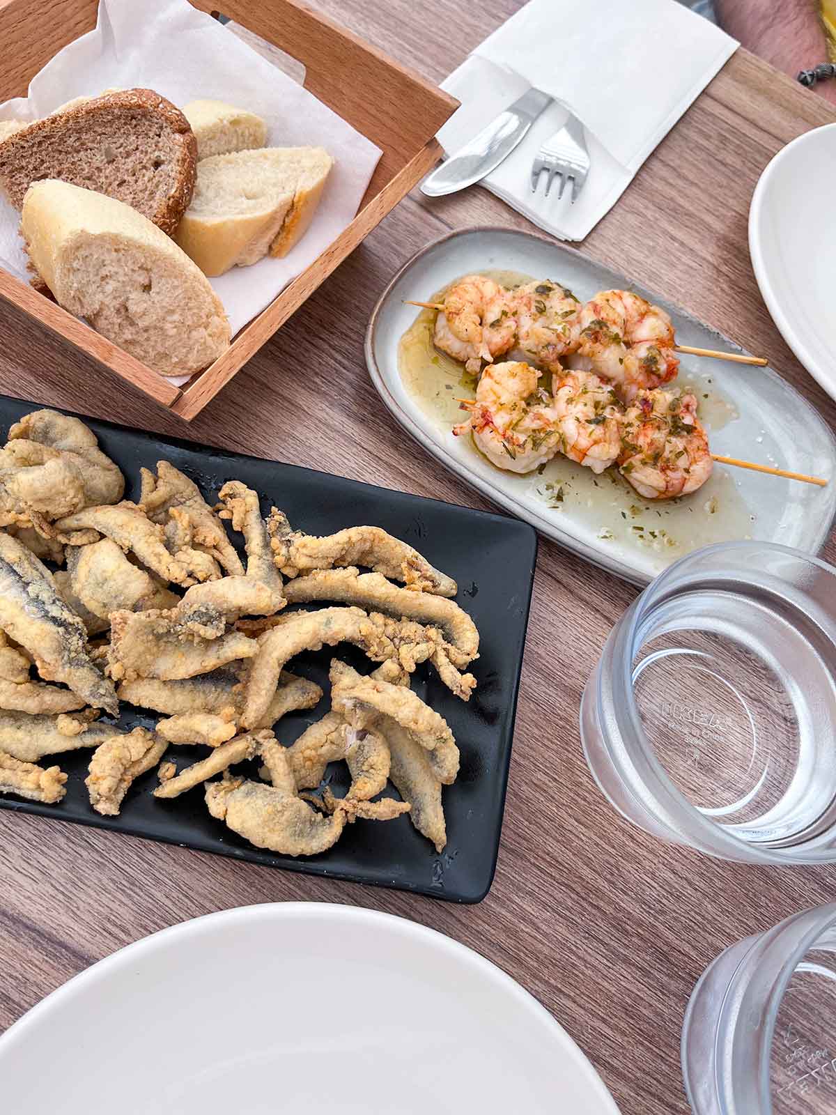 Where to Eat in Estepona (My Top Recommendations) 18 Fried anchovies with lemon and prawn skewers at El Patio del Macerena in Estepona old town, Malaga, Spain.
