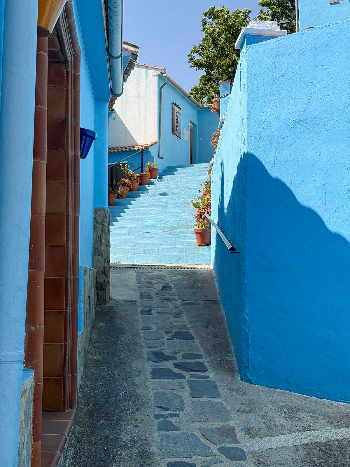 Things to Do in Juzcar, The Blue Village in Malaga 15 Beautiful blue stairs hidden in a street of Juzcar, Malaga.