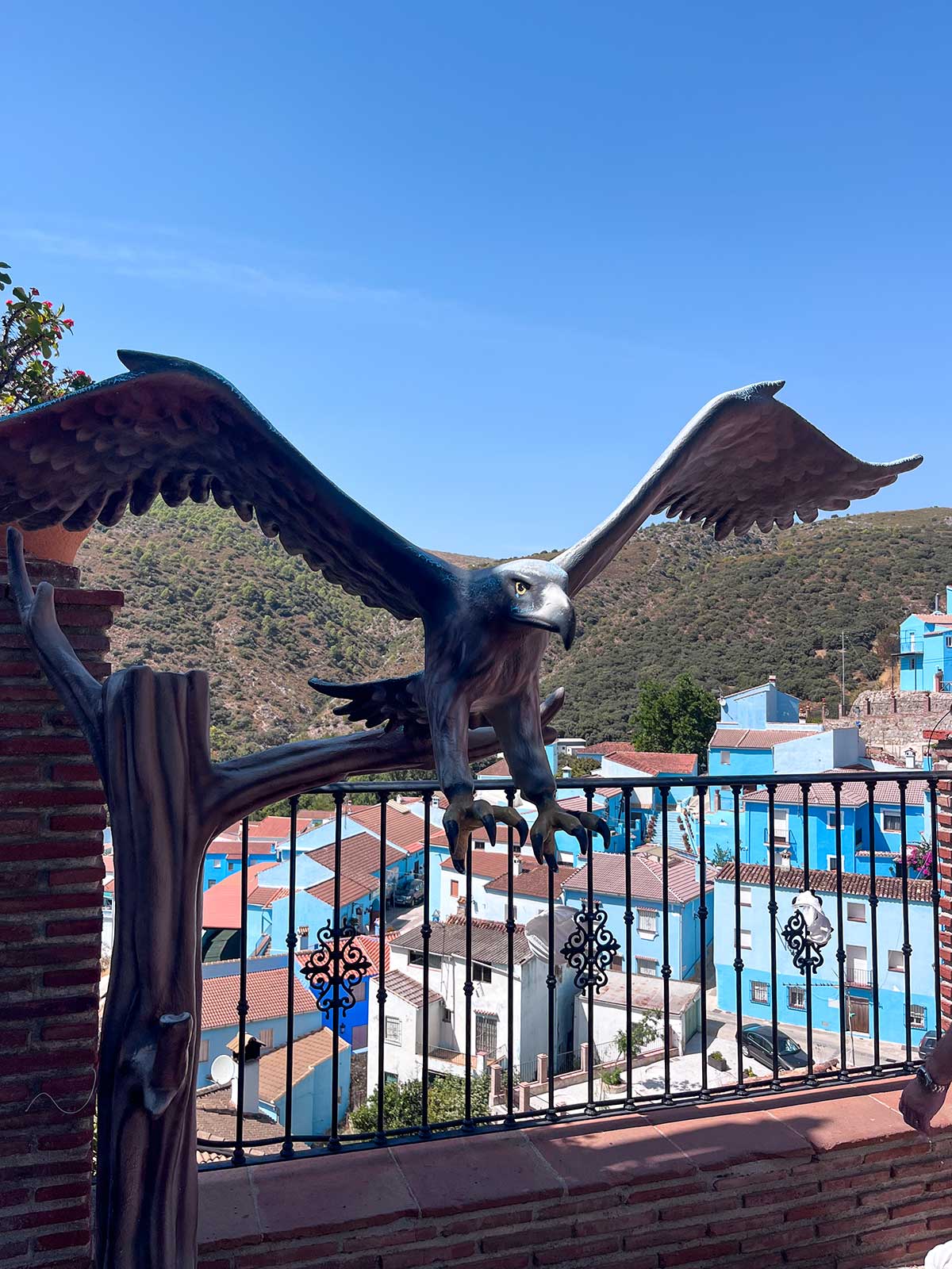 Things to Do in Juzcar, The Blue Village in Malaga 11 Eagle statue in Juzcar, Malaga, Spain.