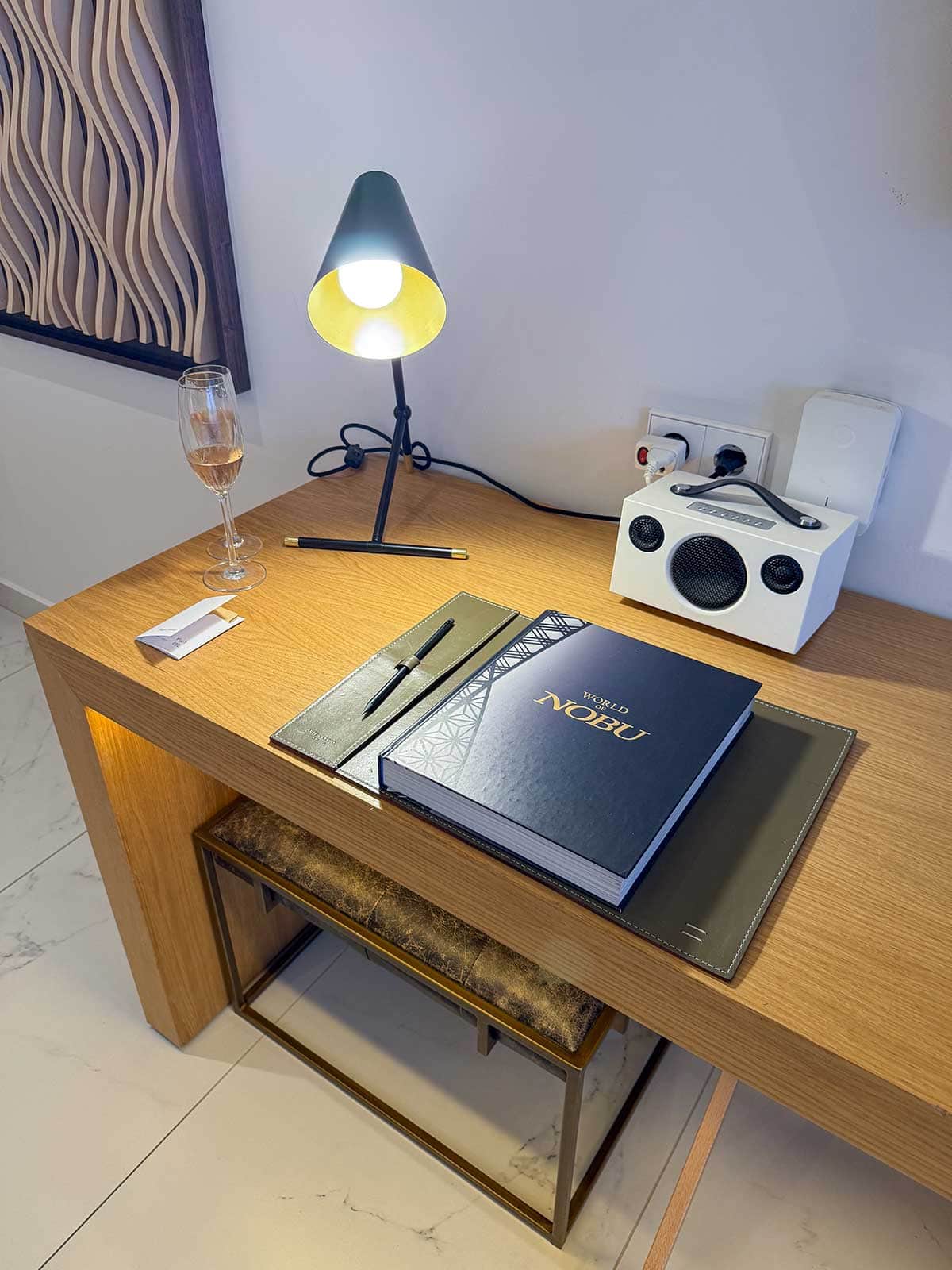 World of Nobu book and radio at a desk in our room at Nobu Marbella.