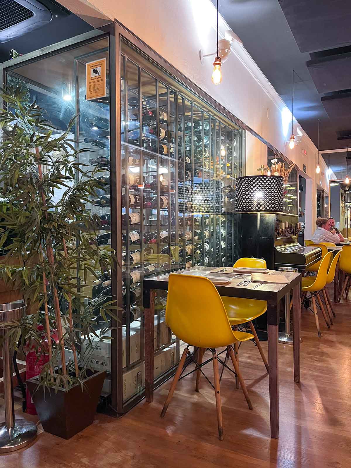 Ultimate Guide to Gluten-Free Seville 2 Indoor seating with wine display at Al Solito Posto in Seville, Spain.
