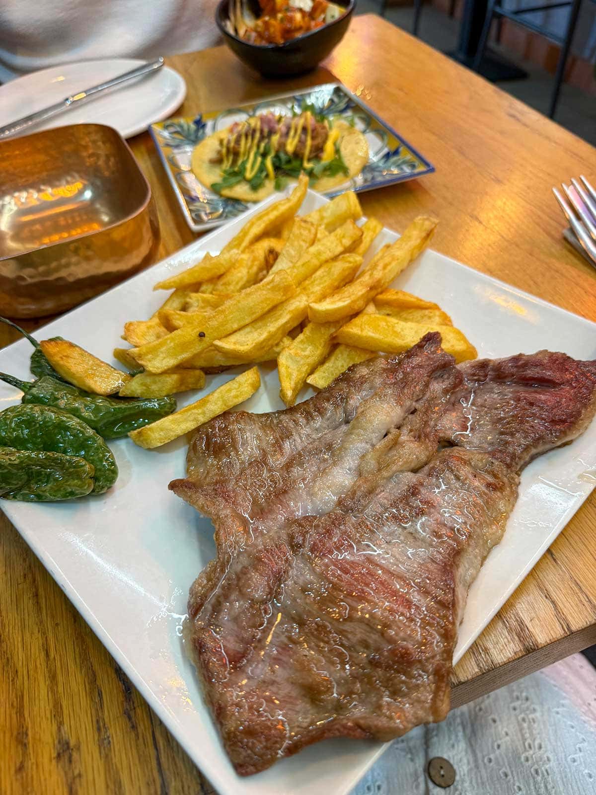 Ultimate Guide to Gluten-Free Seville 14 Secreto iberico with chips and padron peppers at La Bastarda Centro in Seville.